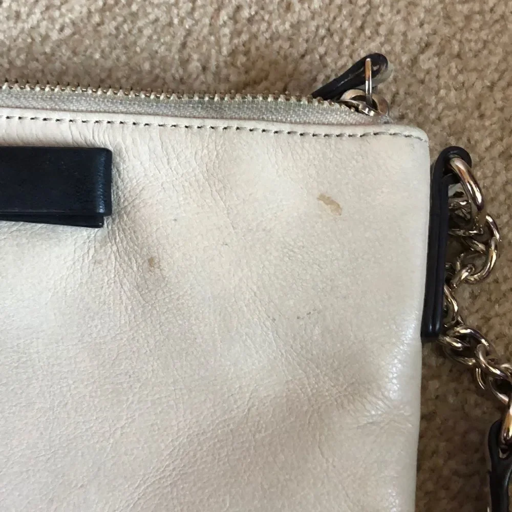 Kate Spade cream purse with a black bow